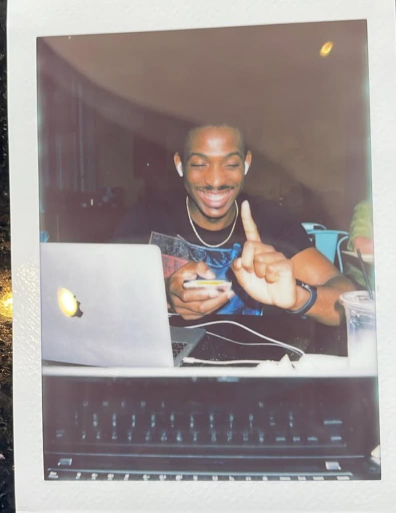 Lapo laughing while working at a laptop