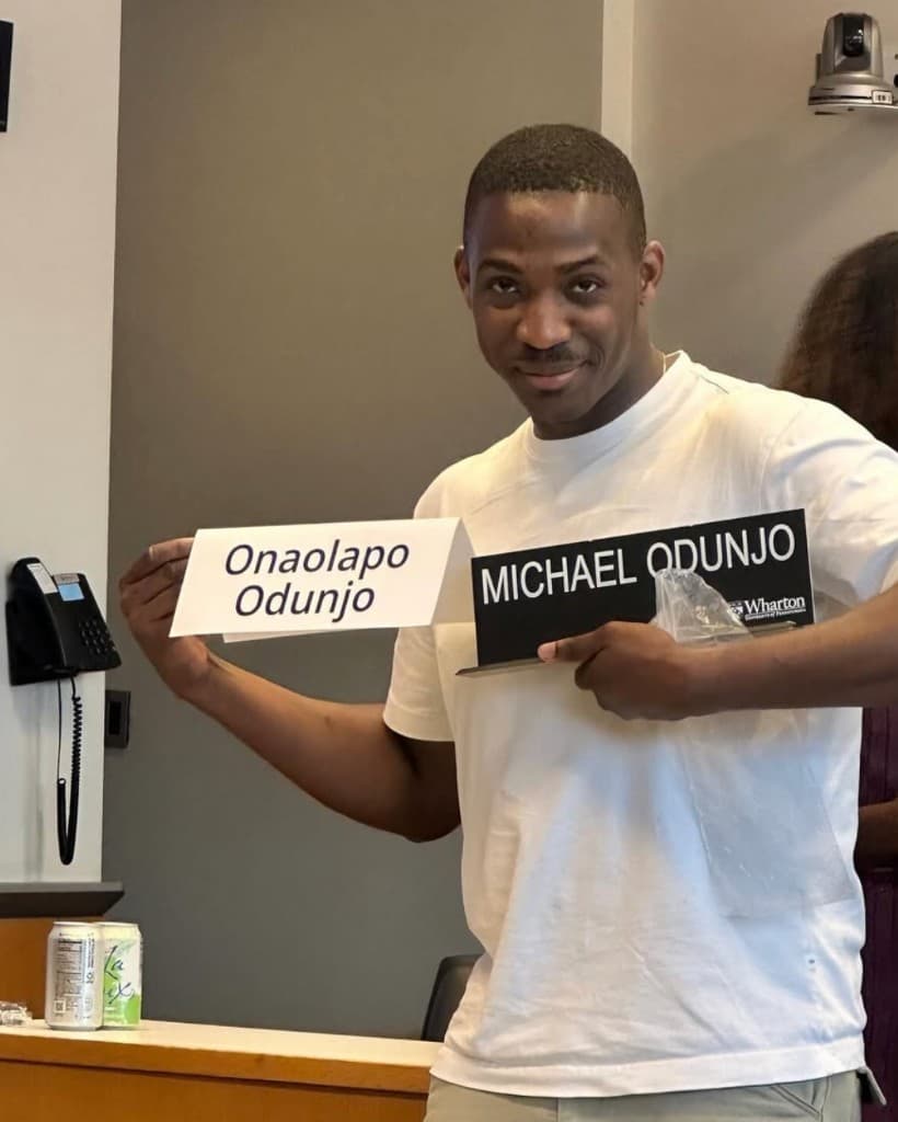 Lapo holding Wharton nameplates for Onaolapo and Michael Odunjo