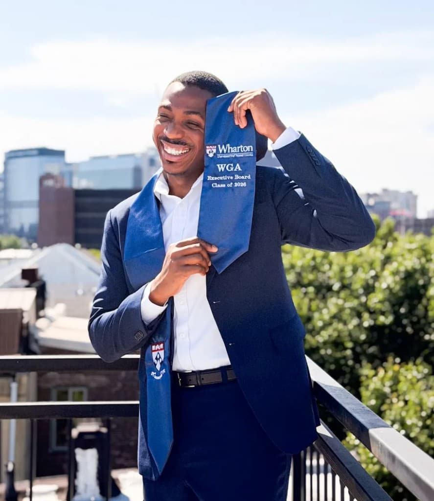 Lapo laughing on a rooftop in a suit with Wharton WGA Executive Board stole